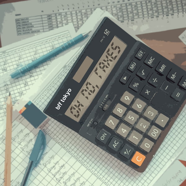 Calculator on a desk with the works "OH NO TAXES" displayed on it